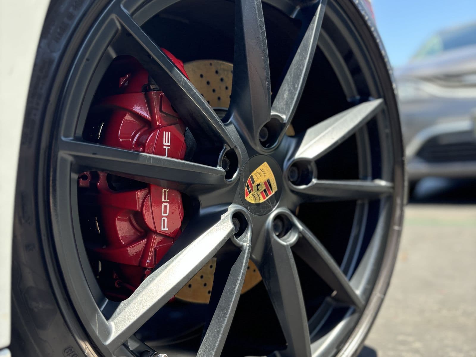 Porsche wheel and red brake caliper, cleaned and dressed